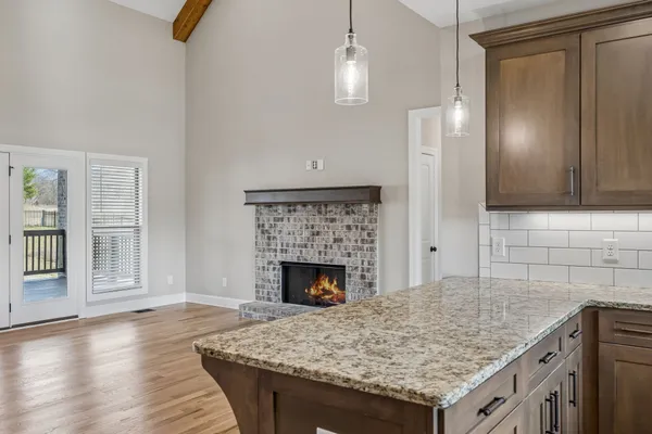 wooden floor fireplace and windows in an empty room