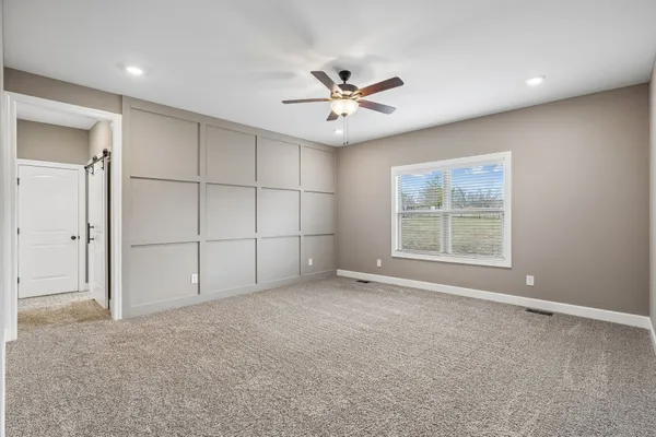 an empty room with closet and windows