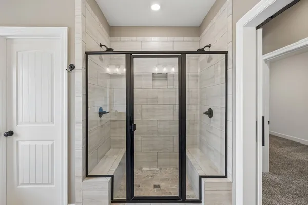 a bathroom with a glass shower door