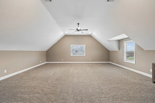 a view of empty room with a fireplace and fan