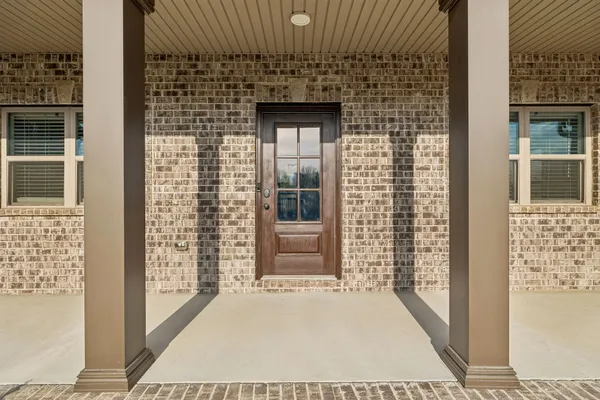 a view of a brick house with large windows