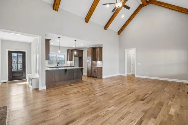 a view of large kitchen with wooden floor and windows
