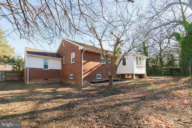 a view of a house with a yard covered in snow