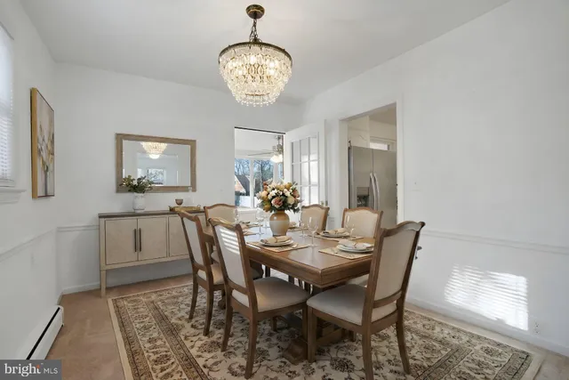 a view of a dining room with furniture and chandelier