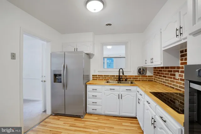 a kitchen with a sink stove and refrigerator
