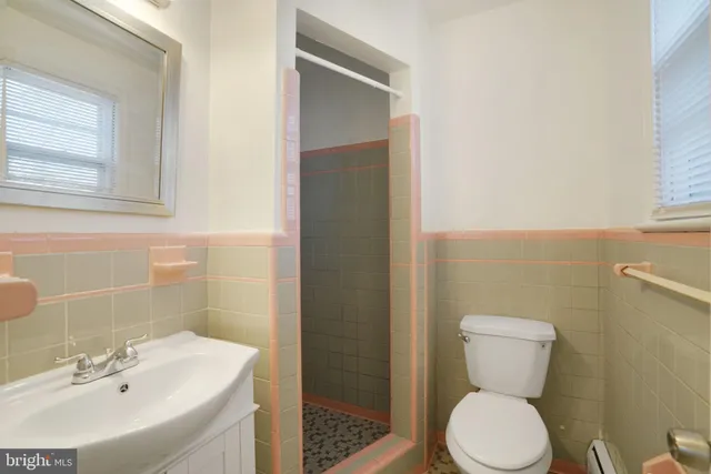 a white toilet sitting next to a bathroom sink