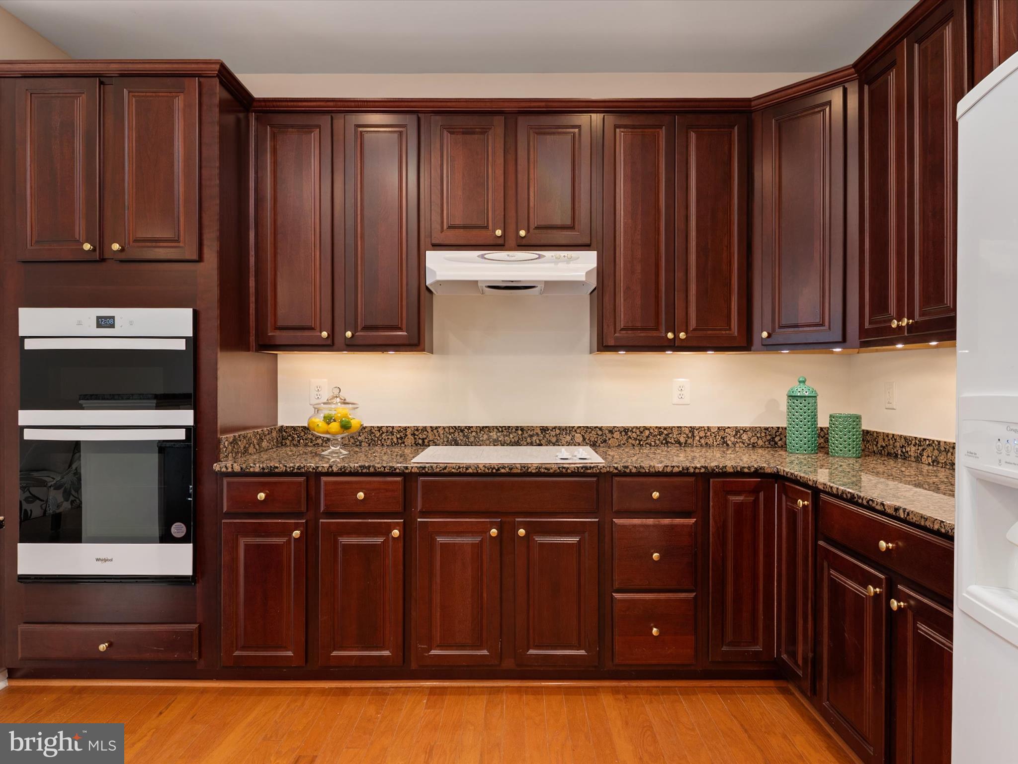 364 Overture Way Centreville, MD 21617 - Photo 16 of 62 a kitchen with granite countertop wooden cabinets and stainless steel appliances