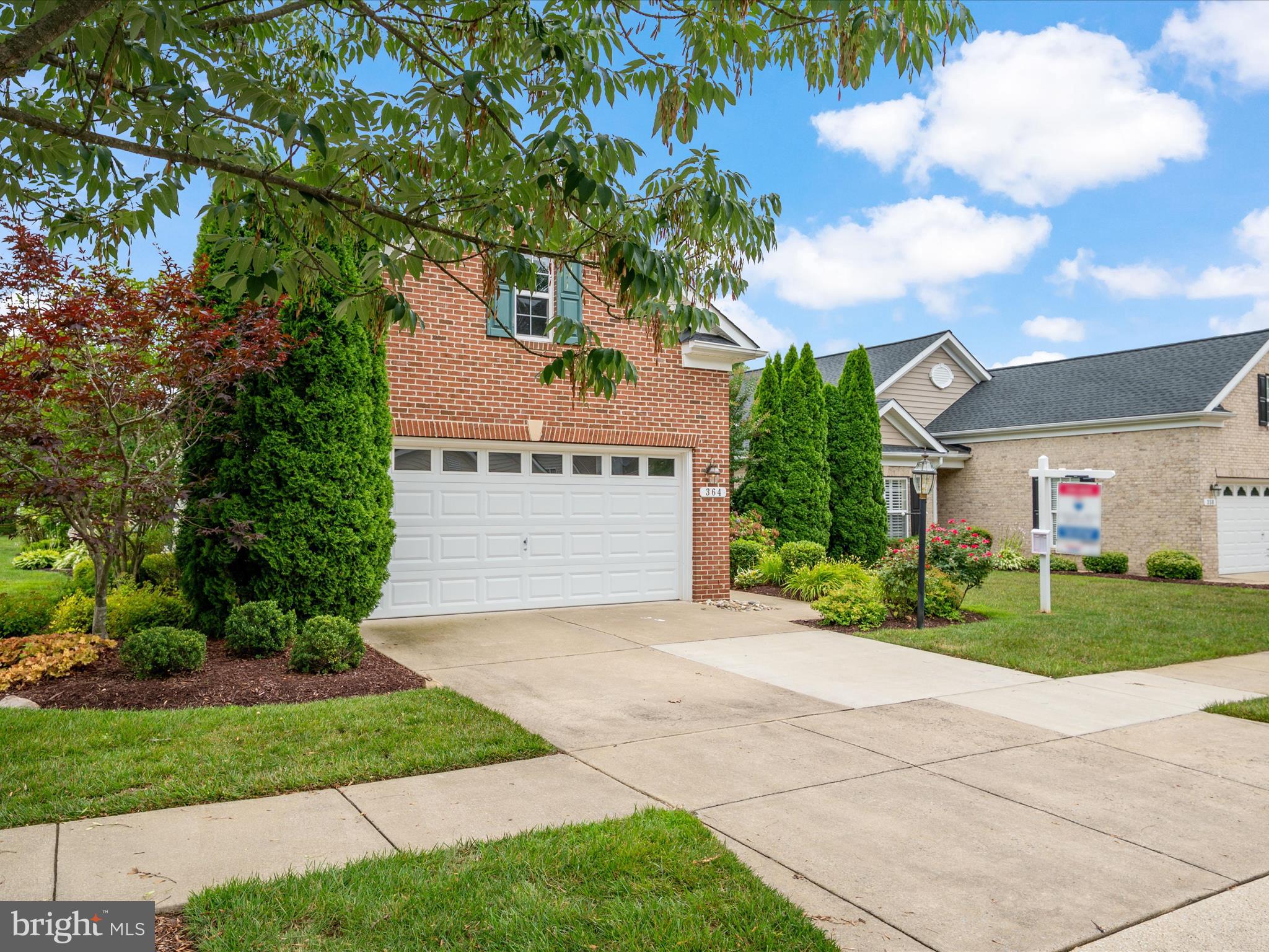 364 Overture Way Centreville, MD 21617 - Photo 4 of 62 a front view of a house with a yard and garage