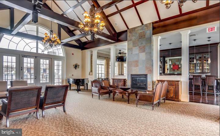 364 Overture Way Centreville, MD 21617 - Photo 42 of 62 a living room with furniture a fireplace and a table