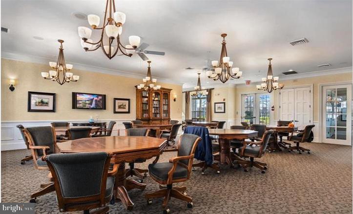 364 Overture Way Centreville, MD 21617 - Photo 44 of 62 a view of a dining room with furniture chandelier and wooden floor