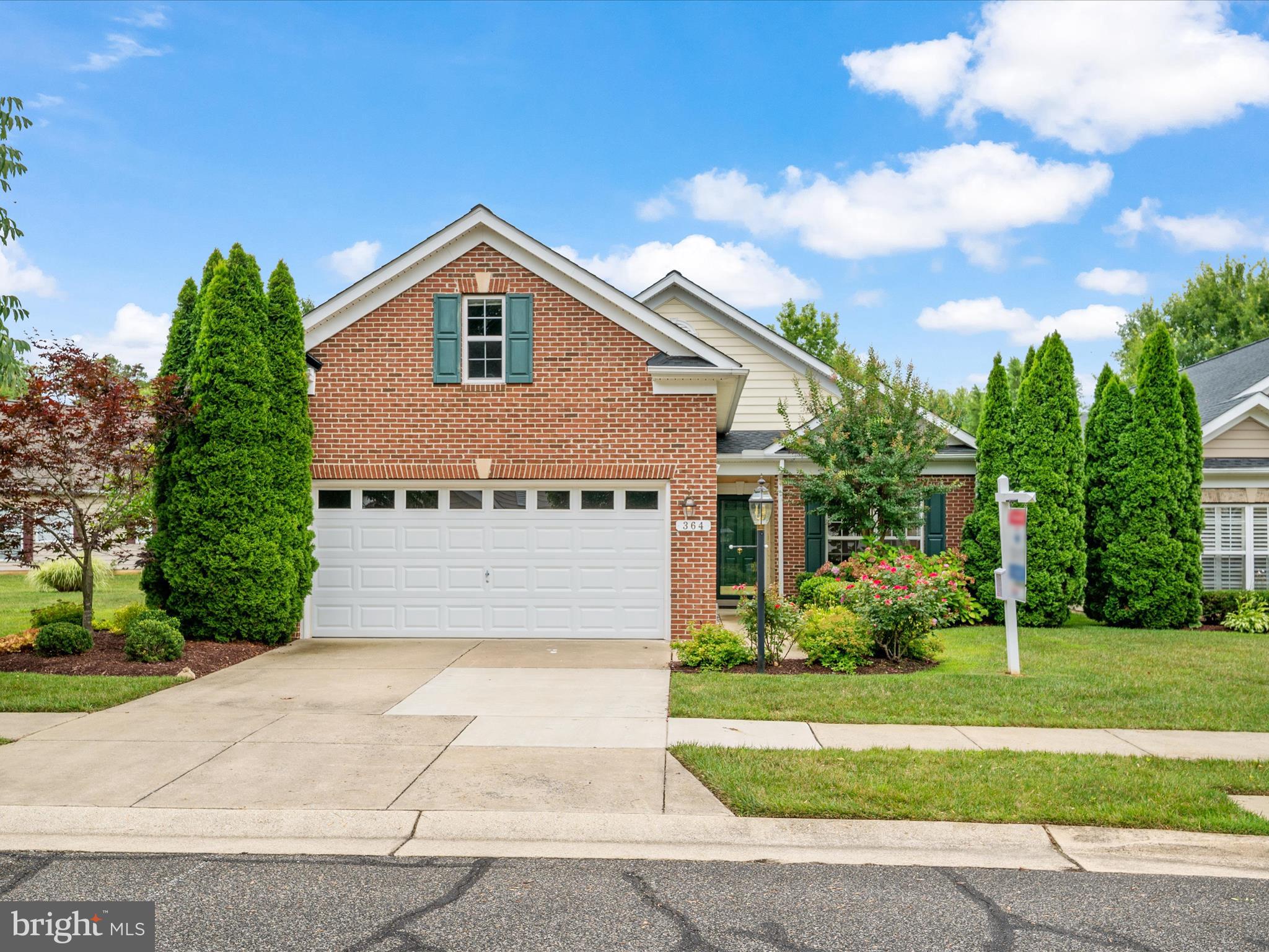 364 Overture Way Centreville, MD 21617 - Photo 5 of 62 a front view of a house with a yard and potted plants