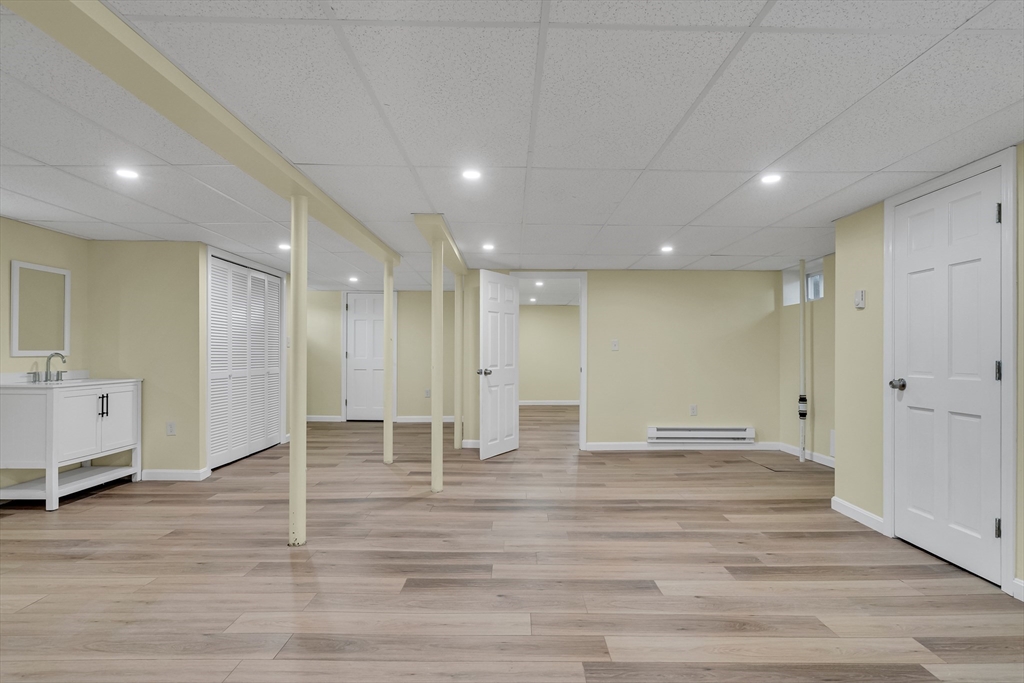 99 Truman Road Newton, MA 02459 - Photo 16 of 26 a view of an empty room with wooden floor