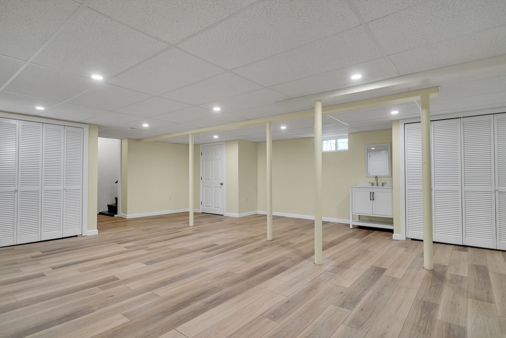 99 Truman Road Newton, MA 02459 - Photo 17 of 26 an empty room with wooden floor and windows