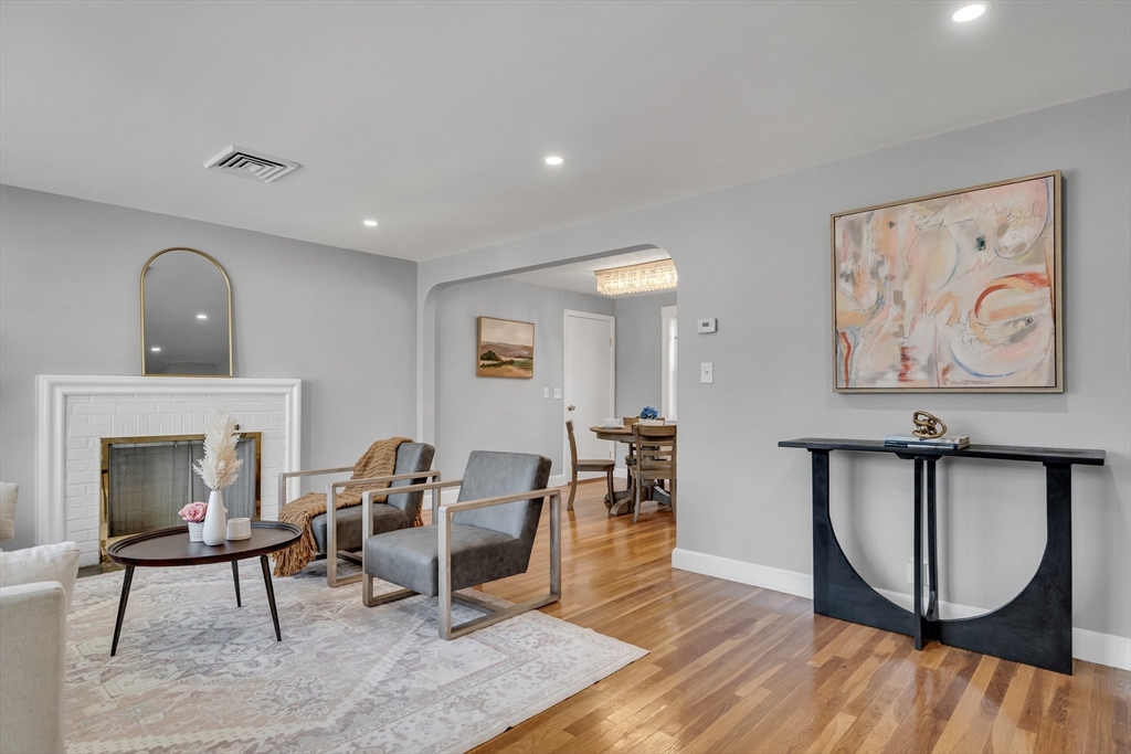 99 Truman Road Newton, MA 02459 - Photo 2 of 26 a living room with furniture a piano and paintings on the wall