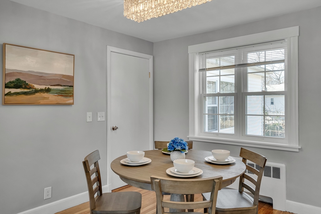 99 Truman Road Newton, MA 02459 - Photo 5 of 26 a view of a dining room that has a table and chairs in it