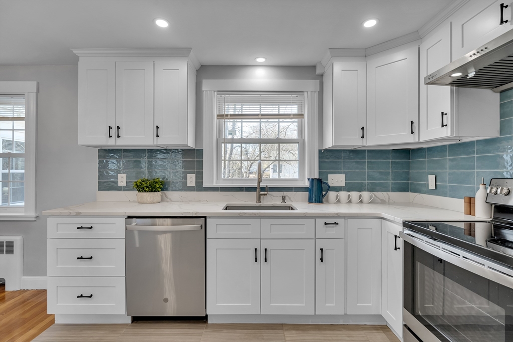 99 Truman Road Newton, MA 02459 - Photo 6 of 26 a kitchen with white cabinets and sink