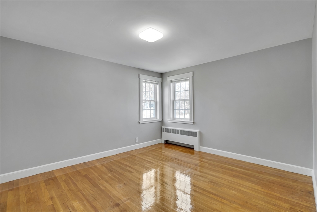 99 Truman Road Newton, MA 02459 - Photo 10 of 26 a view of empty room with wooden floor and fan