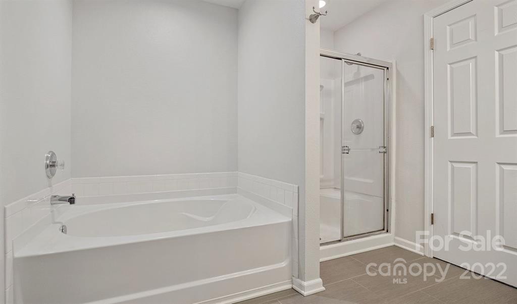 2532 Spring Breeze Way Monroe, NC 28110 - Photo 12 of 21 a bathroom with a bathtub