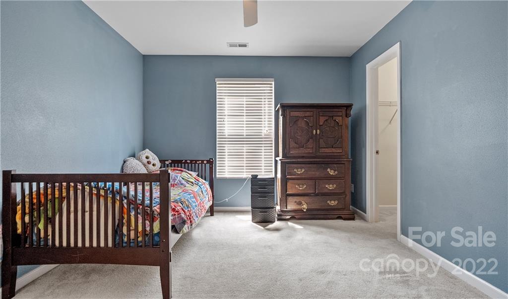 2532 Spring Breeze Way Monroe, NC 28110 - Photo 13 of 21 a bedroom with a bed and furniture