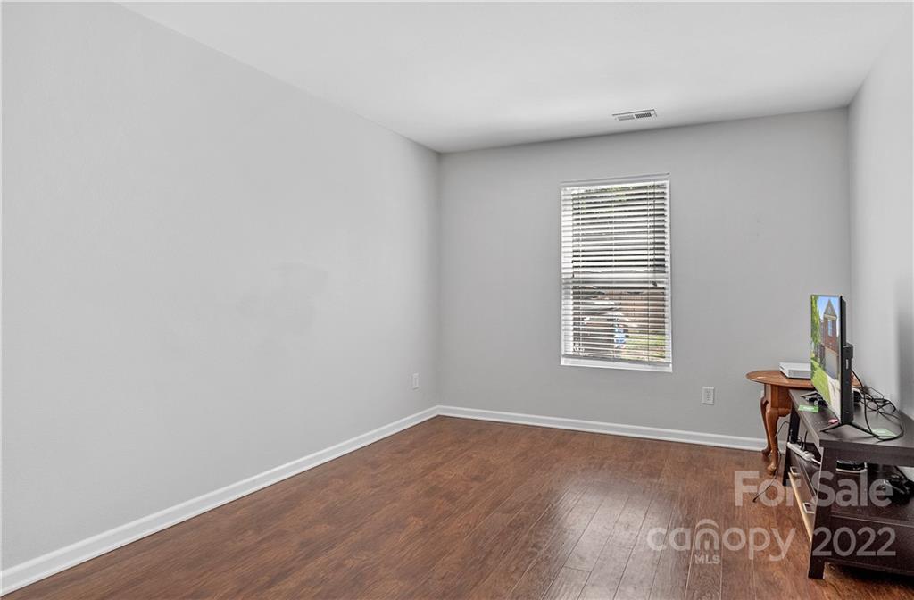2532 Spring Breeze Way Monroe, NC 28110 - Photo 16 of 21 an empty room with wooden floor and a window