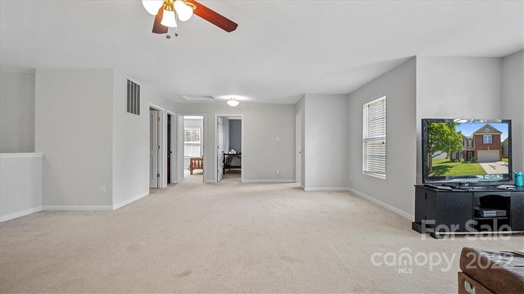 2532 Spring Breeze Way Monroe, NC 28110 - Photo 18 of 21 a view of an empty room with a window and a kitchen
