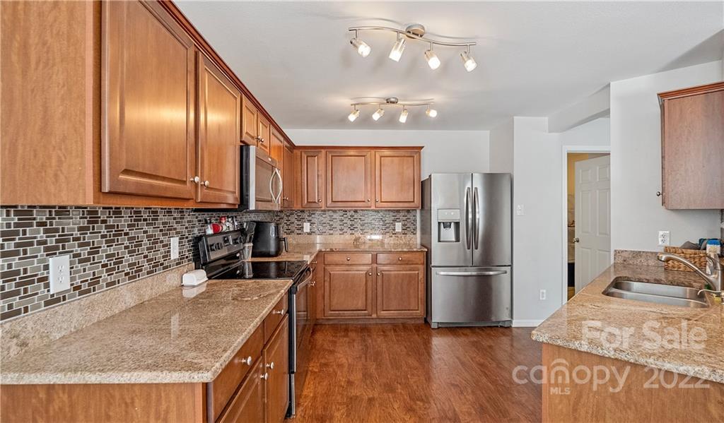 2532 Spring Breeze Way Monroe, NC 28110 - Photo 6 of 21 a kitchen with refrigerator cabinets and wooden floor