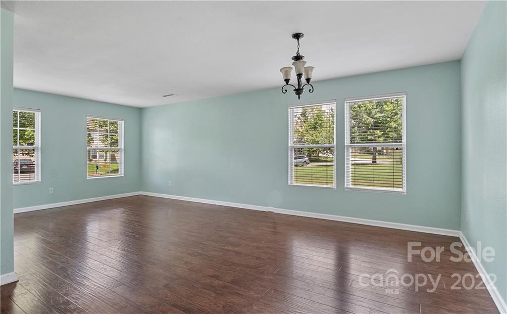 2532 Spring Breeze Way Monroe, NC 28110 - Photo 8 of 21 a view of an empty room with wooden floor and a window