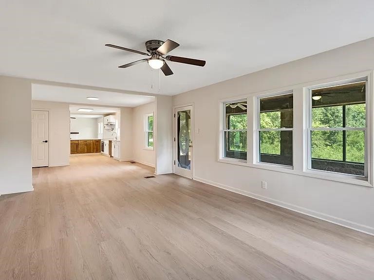 7441 Walsh Road Millington, TN 38053 - Photo 4 of 16 a view of empty room with wooden floor and fan