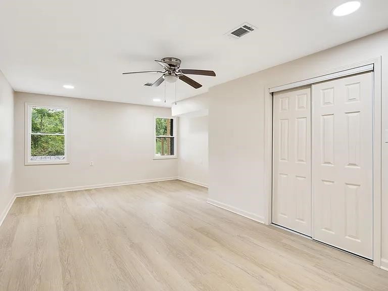 7441 Walsh Road Millington, TN 38053 - Photo 6 of 16 a view of an empty room with a window and wooden floor