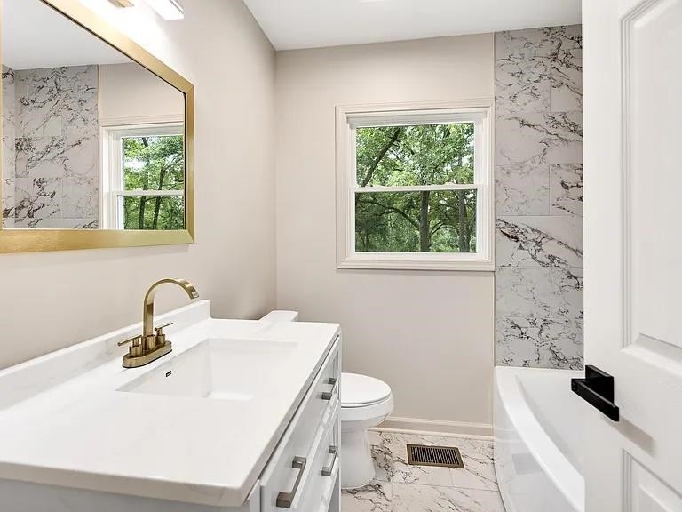 7441 Walsh Road Millington, TN 38053 - Photo 7 of 16 a bathroom with a sink a toilet and a window