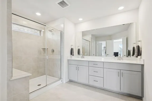 a bathroom with a shower sink and mirror