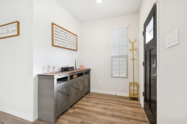 a view of a kitchen with a sink cabinets and wooden floor