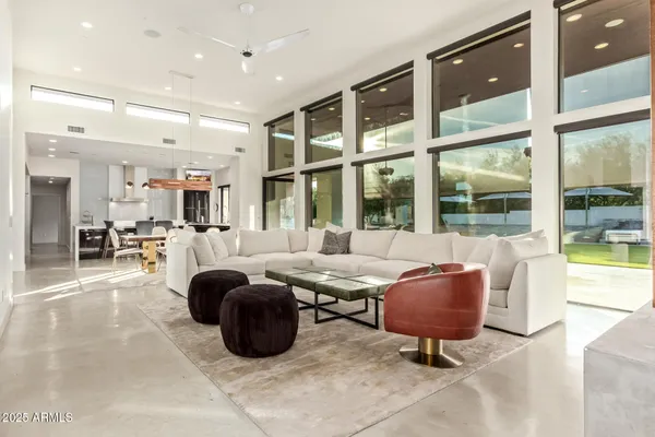 a dining area with stainless steel appliances kitchen island granite countertop a dining table and chairs