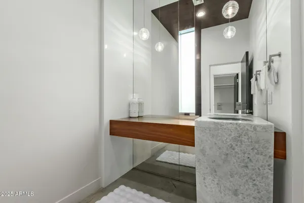 a spacious bathroom with a double vanity sink a mirror and a bathtub