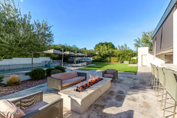 a view of a house with a big yard and a large tree