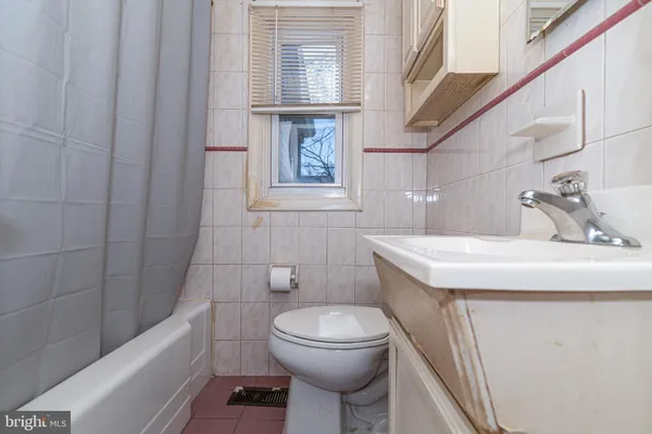 a bathroom with a sink a toilet and bathtub