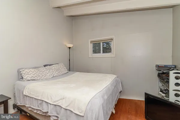 a bedroom with a bed and a night stand