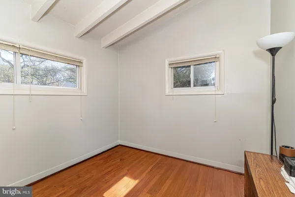 a view of a room with wooden floor and a window