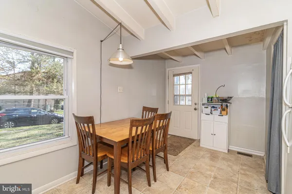 a view of a dining room with furniture and a window