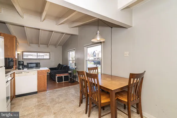 a view of a dining room with furniture and a kitchen