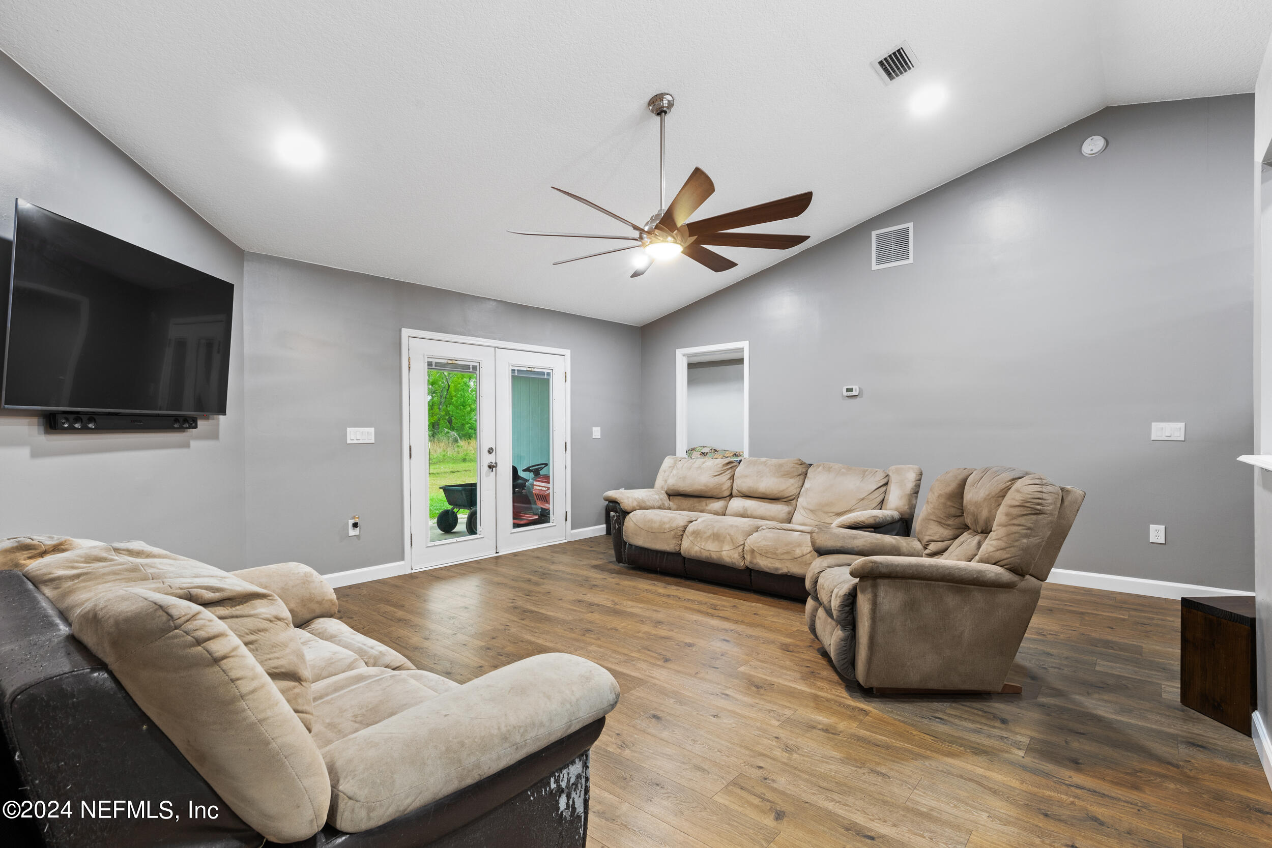 7191 Raleigh Road Keystone Heights, FL 32656 - Photo 3 of 31 a living room with furniture and a flat screen tv