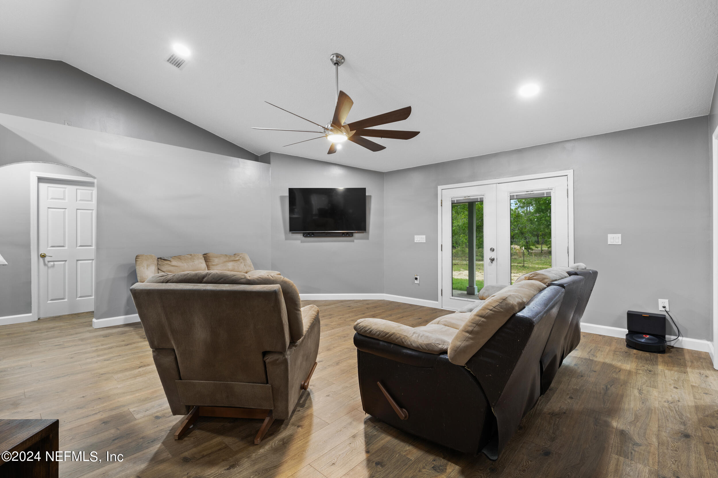 7191 Raleigh Road Keystone Heights, FL 32656 - Photo 4 of 31 a living room with furniture and a flat screen tv