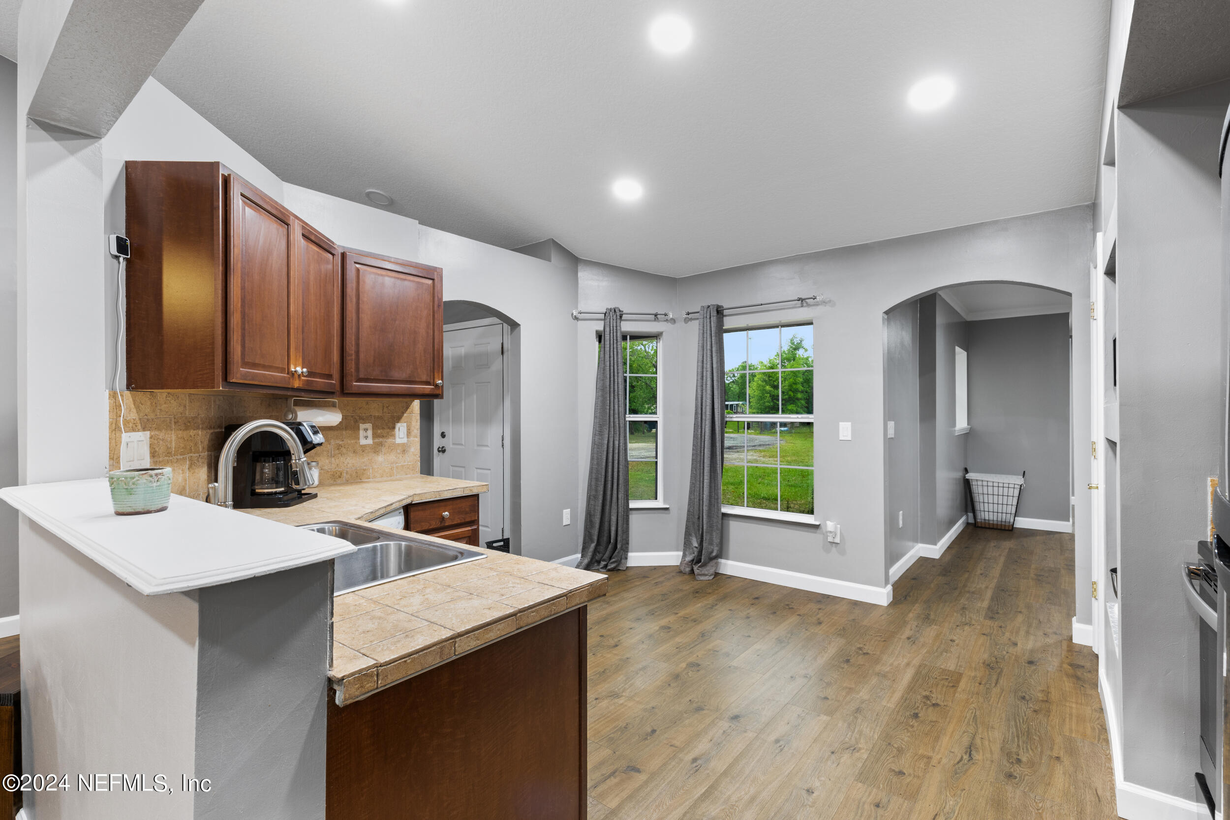 7191 Raleigh Road Keystone Heights, FL 32656 - Photo 8 of 31 a view of a kitchen with a sink dishwasher wooden floor and a kitchen