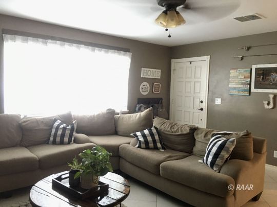509 South Appaloosa Street Ridgecrest, CA 93555 - Photo 21 of 26 a living room with furniture and a large window