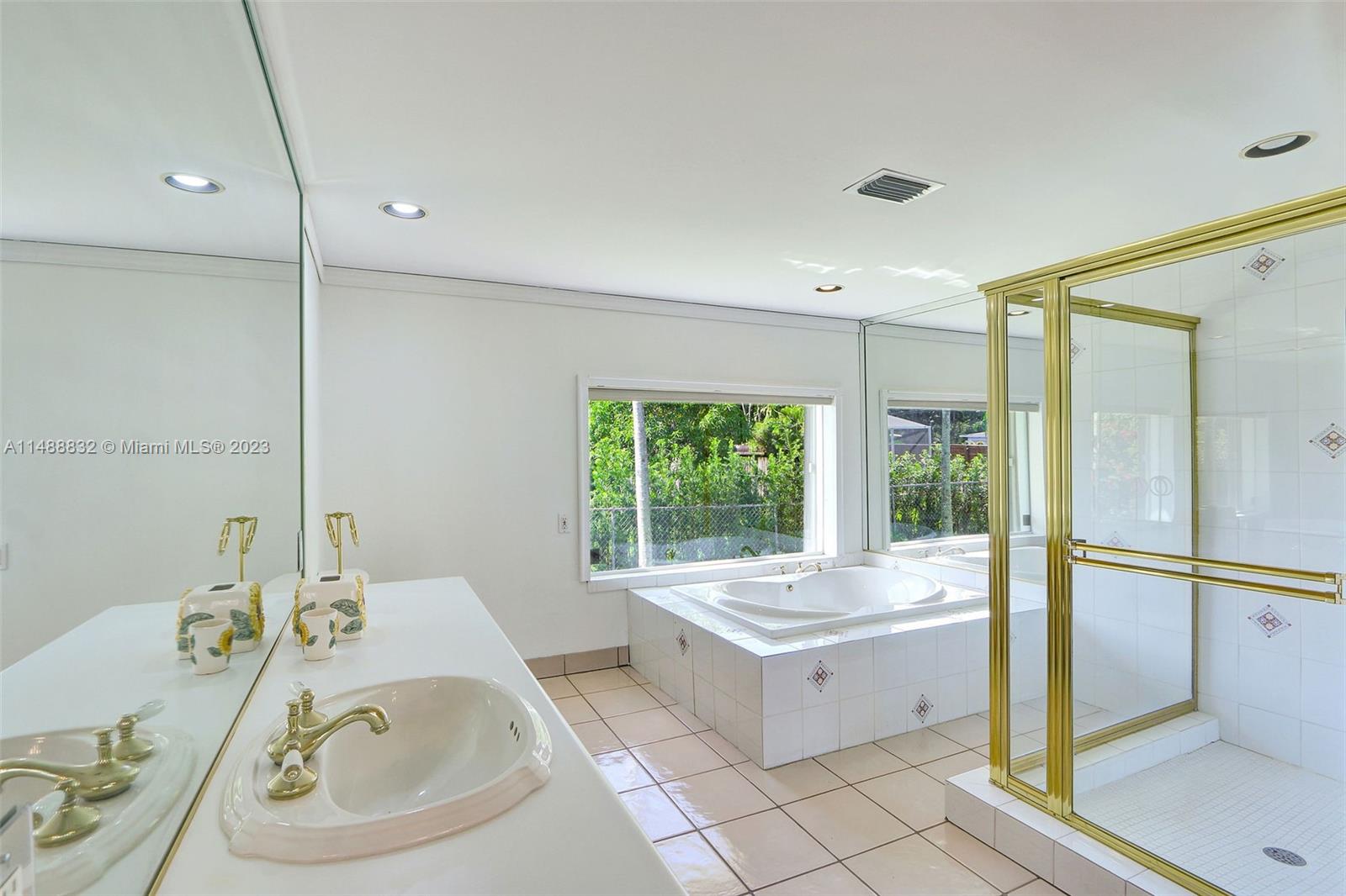 10455 Southwest 112th Street Miami, FL 33176 - Photo 15 of 21 a bathroom with a tub sink shower and mirror