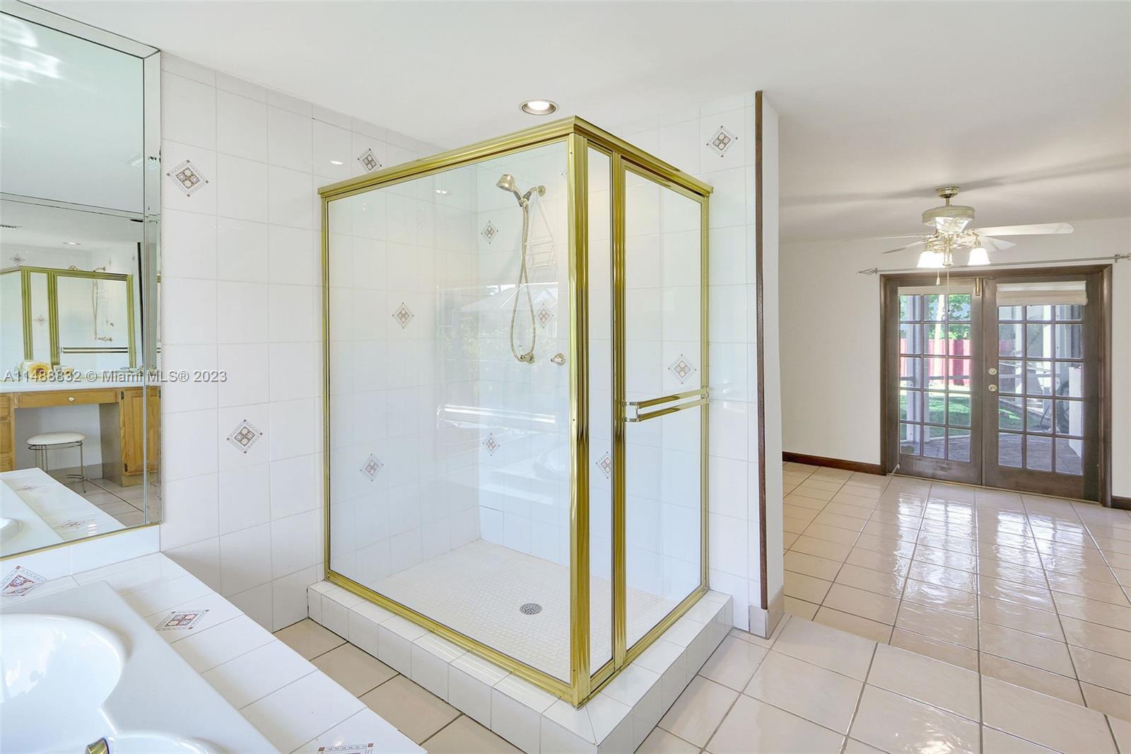 10455 Southwest 112th Street Miami, FL 33176 - Photo 16 of 21 a bathroom with a glass shower door and a bathtub