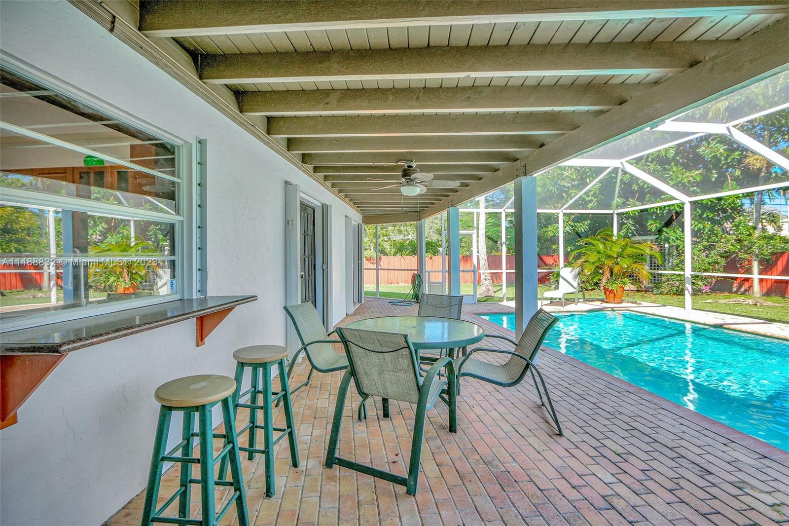 10455 Southwest 112th Street Miami, FL 33176 - Photo 4 of 21 a view of a chairs and table in patio with a backyard