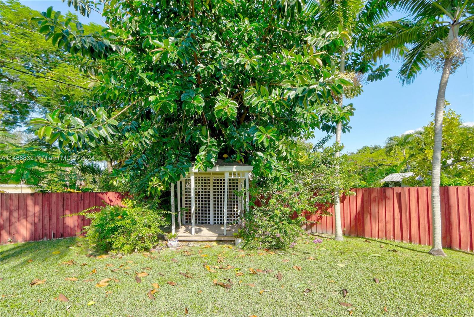 10455 Southwest 112th Street Miami, FL 33176 - Photo 7 of 21 a view of backyard with wooden fence and large trees
