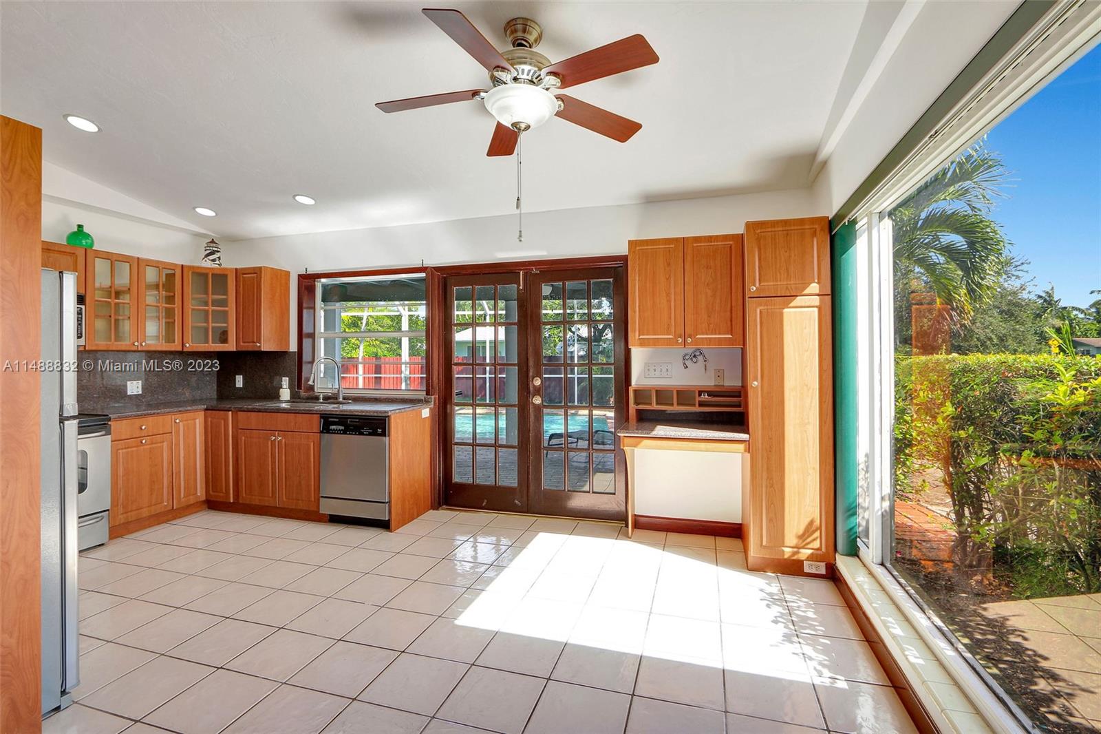 10455 Southwest 112th Street Miami, FL 33176 - Photo 9 of 21 a large kitchen with stainless steel appliances kitchen island granite countertop a refrigerator oven a sink and dishwasher