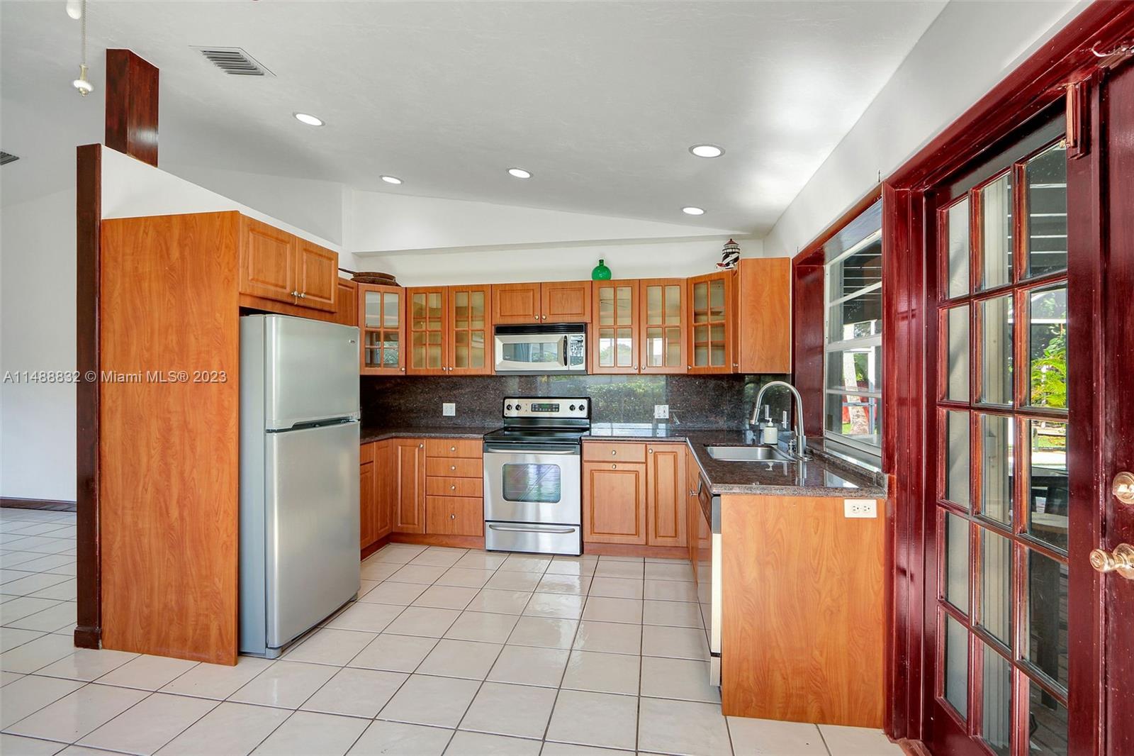 10455 Southwest 112th Street Miami, FL 33176 - Photo 10 of 21 a kitchen with stainless steel appliances granite countertop a refrigerator and a stove top oven